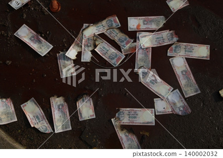 Burning Indian Currency closeup Burning Indian Currency closeup 140002032