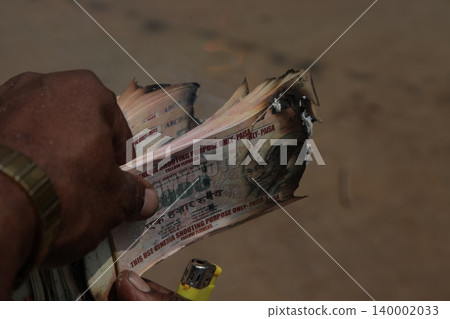 Burning Indian Currency closeup Burning Indian Currency closeup 140002033