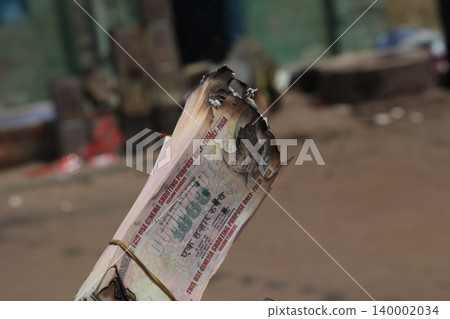 Burning Indian Currency closeup Burning Indian Currency closeup 140002034