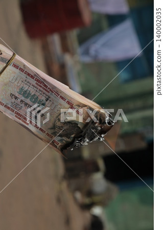 Burning Indian Currency closeup Burning Indian Currency closeup 140002035