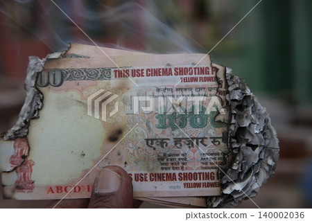 Burning Indian Currency closeup Burning Indian Currency closeup 140002036