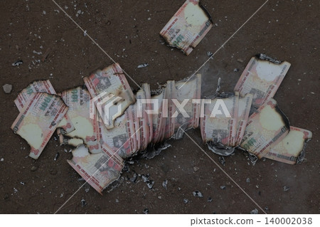 Burning Indian Currency closeup Burning Indian Currency closeup 140002038