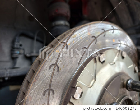 Close-up of high performance slotted car brake rotor disc Close-up of high performance slotted car brake rotor disc 140002273
