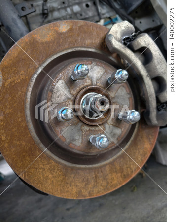 Close-up of rusty car brake disc rotor and caliper Close-up of rusty car brake disc rotor and caliper 140002275