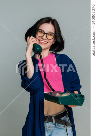 Woman emotionally talking on retro wired phone explaining something actively expressive reaction 140002376