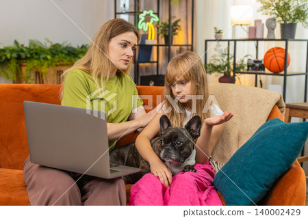 Mother daughter dog lose contest or game on laptop sigh feel sad support each other hug family care Mother daughter dog lose contest or game on laptop sigh feel sad support each other hug family care 140002429