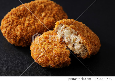 Crispy beef croquettes placed on a black background. Crispy beef croquettes placed on a black background. 140002679