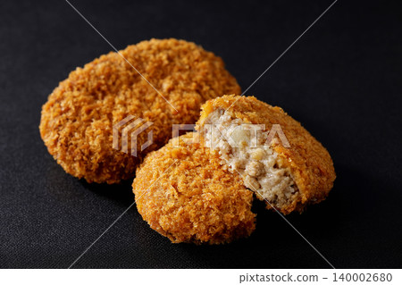 Crispy beef croquettes placed on a black background. Crispy beef croquettes placed on a black background. 140002680