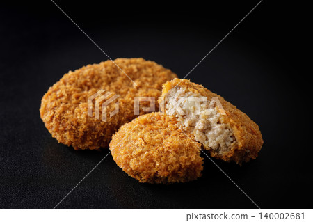 酥脆的牛肉丸子擺放在黑色背景上。 酥脆的牛肉丸子擺放在黑色背景上。 140002681