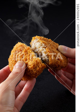 Crispy beef croquettes placed on a black background. Crispy beef croquettes placed on a black background. 140002691