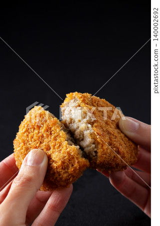 Crispy beef croquettes placed on a black background. Crispy beef croquettes placed on a black background. 140002692