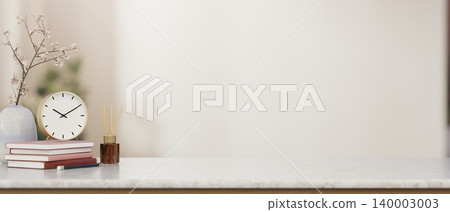 Round clock over books beside flower vase and diffuser on marble countertop table in white wall room 140003003