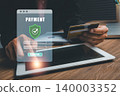Image depicting secure digital payment with a credit card and tablet, emphasizing online transaction safety and data protection. 140003352