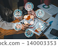 Dynamic team collaboration using digital tools for effective communication and productivity in a modern office setting. 140003353