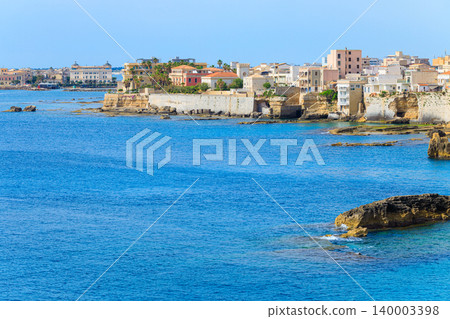 Ancient Greek city waterfront district with marble houses overlooking the blue sea 140003398