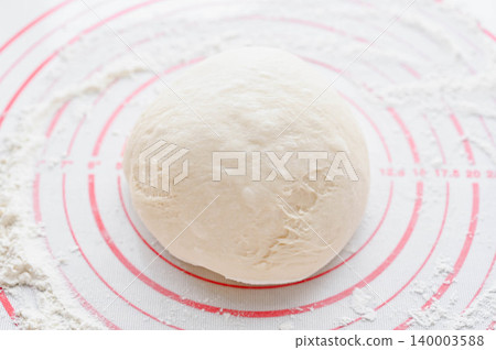 The dough has been deflated and reshaped into a ball. The dough has been deflated and reshaped into a ball. 140003588
