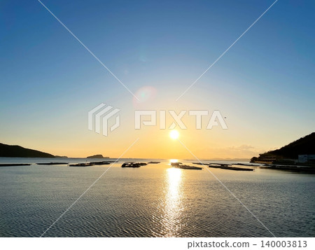 A calm sea and the rising sun 140003813