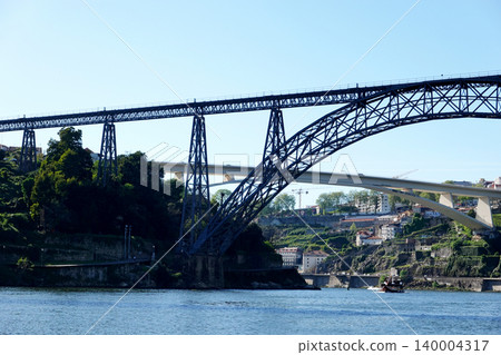Low angle view of Maria Pia Bridge and Infante Bridge over the Douro River in Porto, Portugal Low angle view of Maria Pia Bridge and Infante Bridge over the Douro River in Porto, Portugal 140004317