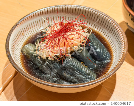 Japanese-style simmered eggplant. Eggplant simmered in a flavorful broth. Topped with bonito flakes. Japanese-style simmered eggplant. Eggplant simmered in a flavorful broth. Topped with bonito flakes. 140004617