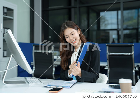 Asian businesswoman presenting ideas and analyzing financial charts during an online meeting. Asian businesswoman presenting ideas and analyzing financial charts during an online meeting. 140004710