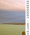 Panoramic coastal landscape with vibrant turquoise water and a soft pink gradient sky. 140004838