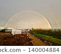 Stunning double rainbow forming a perfect arch over an archaeological excavation site by the sea. 140004884