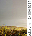 Scenic landscape of sunlit mountains and coastal trees under a dramatic post-storm sky by the sea. 140004937