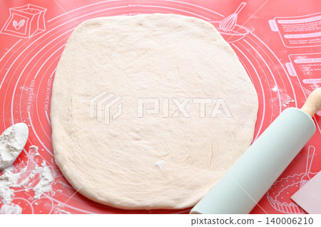 Roll out the dough with a rolling pin Roll out the dough with a rolling pin 140006210