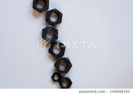 Hexagonal bolts and nuts placed in the white scene Hexagonal bolts and nuts placed in the white scene 140006393