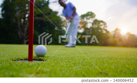 Golfers are putting golf in the evening golf course golf backglound. Golfers are putting golf in the evening golf course golf backglound. 140006452