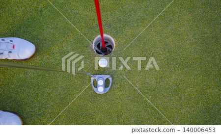 Golfers are putting golf in the evening golf course golf backglound. 140006453