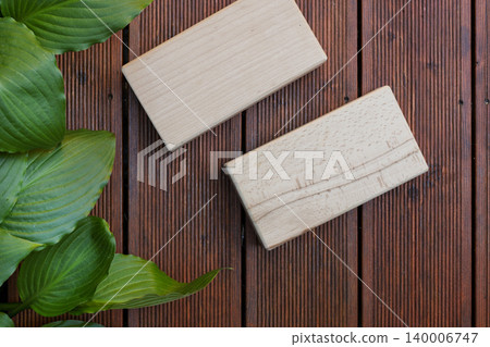 Wooden Yoga Blocks on Dark Decking Boards 140006747
