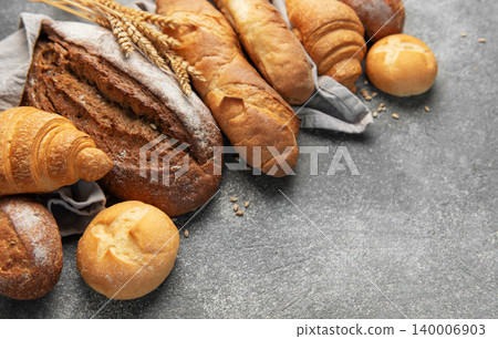 Fresh baked bread, baguettes, croissants, and buns assortment Fresh baked bread, baguettes, croissants, and buns assortment 140006903