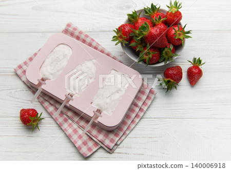 Making homemade strawberry ice cream popsicles in silicone mold Making homemade strawberry ice cream popsicles in silicone mold 140006918