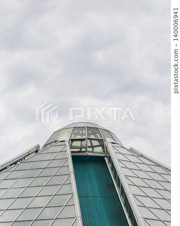 Modern Architectural Roof Detail with Slanted Panels and Teal Steel Truss Modern Architectural Roof Detail with Slanted Panels and Teal Steel Truss 140006941