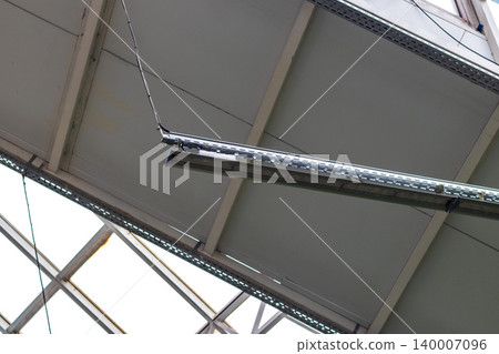 An indoor tropical garden or greenhouse atrium setting illuminated by artificial overhead lighting An indoor tropical garden or greenhouse atrium setting illuminated by artificial overhead lighting 140007096