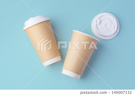 Paper takeaway cup with lid on pastel blue background 140007132