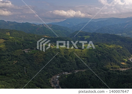 An aerial photograph overlooking the mountain valleys around Mount Hiei in Nobeoka City, Miyazaki Prefecture. An aerial photograph overlooking the mountain valleys around Mount Hiei in Nobeoka City, Miyazaki Prefecture. 140007647