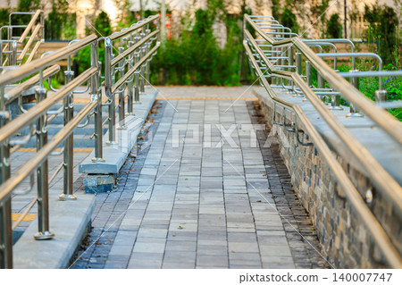 city square park paved street tile track smooth foot path way with hand rail metallic urban object city square park paved street tile track smooth foot path way with hand rail metallic urban object 140007747