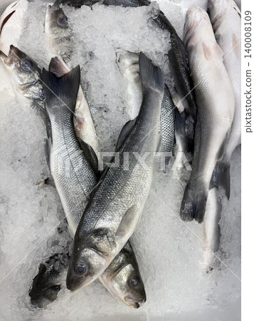 Fresh fish on ice in market display for sale, showcasing seafood options available for purchase Fresh fish on ice in market display for sale, showcasing seafood options available for purchase 140008109