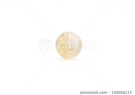 Golden rutilated quartz sphere placed on a white background 140008215