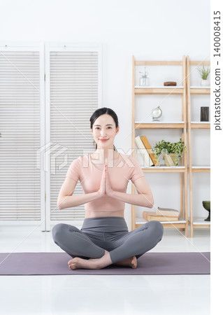 A woman doing yoga at home A woman doing yoga at home 140008415