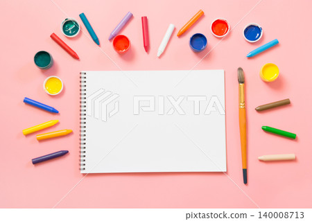 Back to school. Colorful wax crayons and album on pink. 140008713