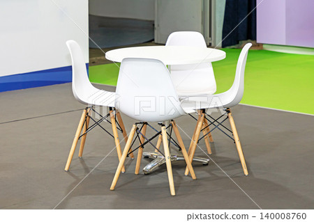 Plastic chairs and table outside 140008760