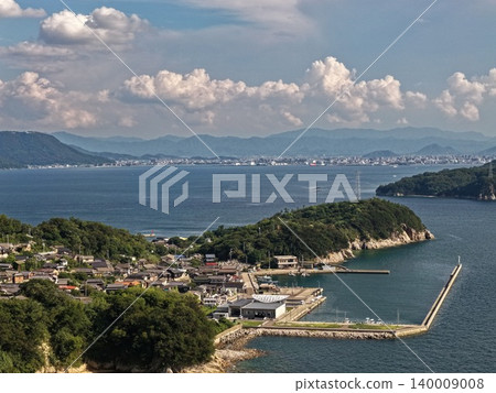 An aerial photograph overlooking the port of Ogijima Island in Kagawa Prefecture and the Seto Inland Sea. An aerial photograph overlooking the port of Ogijima Island in Kagawa Prefecture and the Seto Inland Sea. 140009008