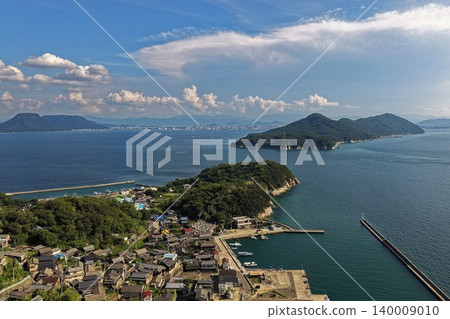 An aerial photograph overlooking the village on Ogijima Island in Kagawa Prefecture and the Seto Inland Sea. An aerial photograph overlooking the village on Ogijima Island in Kagawa Prefecture and the Seto Inland Sea. 140009010