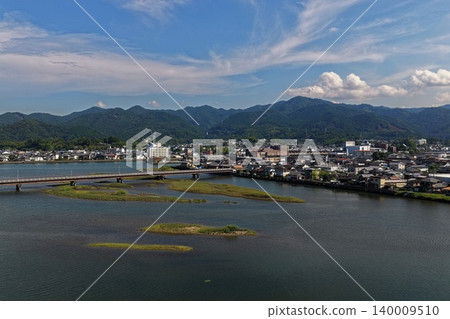 An aerial photograph capturing the city of Usuki in Oita Prefecture, along with its river, bridge, and mountain range. An aerial photograph capturing the city of Usuki in Oita Prefecture, along with its river, bridge, and mountain range. 140009510