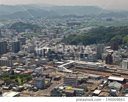 An aerial photograph overlooking the city center and train station of Nobeoka City, Miyazaki Prefecture. An aerial photograph overlooking the city center and train station of Nobeoka City, Miyazaki Prefecture. 140009661
