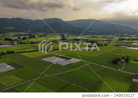 An aerial photograph overlooking the rural landscape and rice paddies of Takamori, Minami-Aso, Kumamoto Prefecture. An aerial photograph overlooking the rural landscape and rice paddies of Takamori, Minami-Aso, Kumamoto Prefecture. 140010127