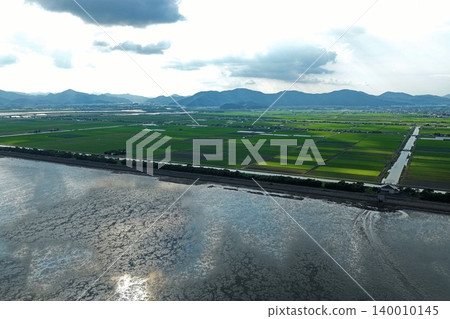 Aerial photograph capturing the Ariake Sea tidal flats and reclaimed rice paddies in Kishima District, Saga Prefecture. Aerial photograph capturing the Ariake Sea tidal flats and reclaimed rice paddies in Kishima District, Saga Prefecture. 140010145